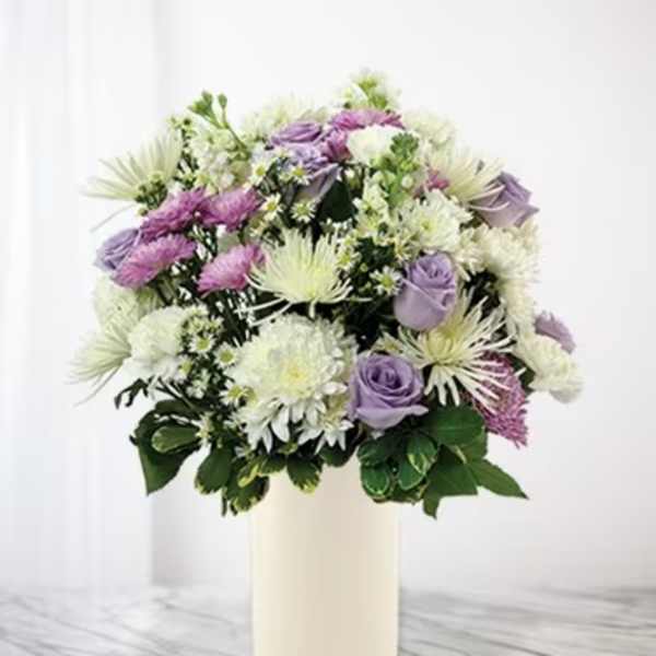 Lavender and white mixed bouquet in a cream vase