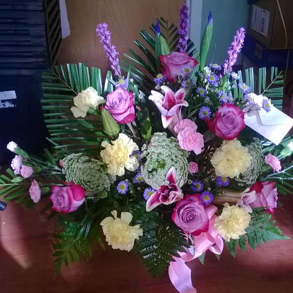 Large bouquet with pink roses, lilies, and pale carnations