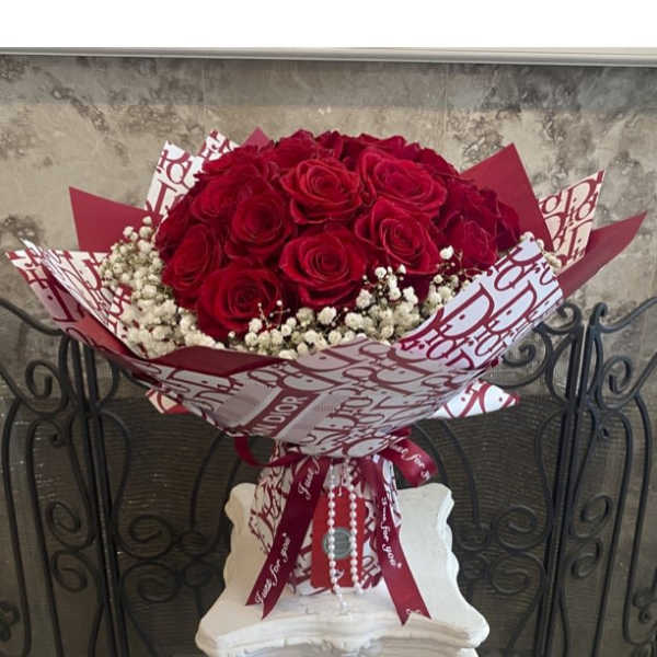Red Roses With Baby Breath In Designed Wrapping Waterproof Paper