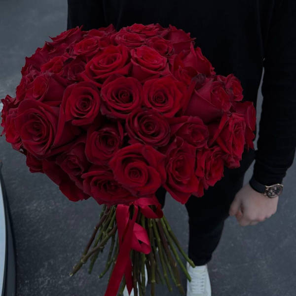 Large bouquet of red roses tied with a red ribbon