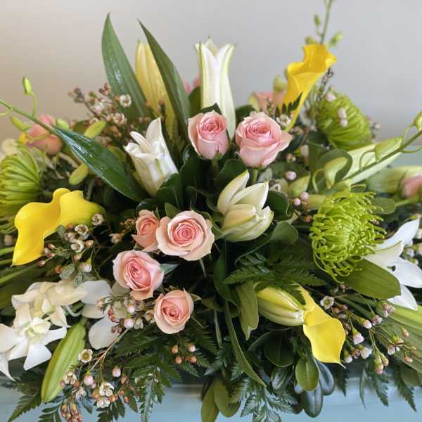 Mixed bouquet with pink roses, white lilies, and yellow calla lilies