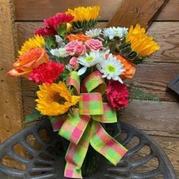Colorful bouquet of mixed flowers tied with a bright ribbon