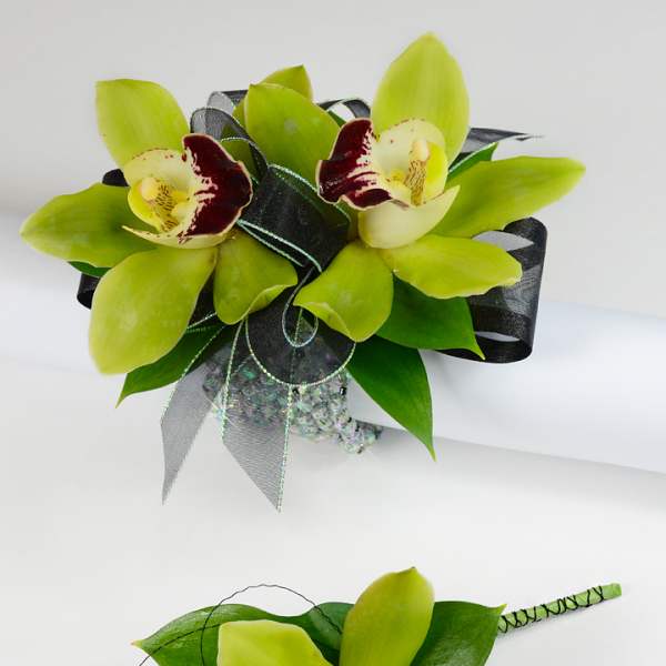 Green orchid bouquet and matching boutonniere with dark ribbon