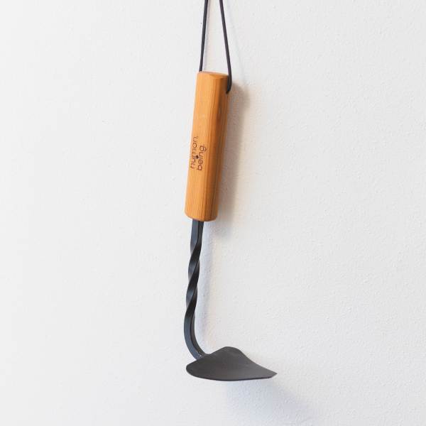 Wooden hanging tool with a black metal blade