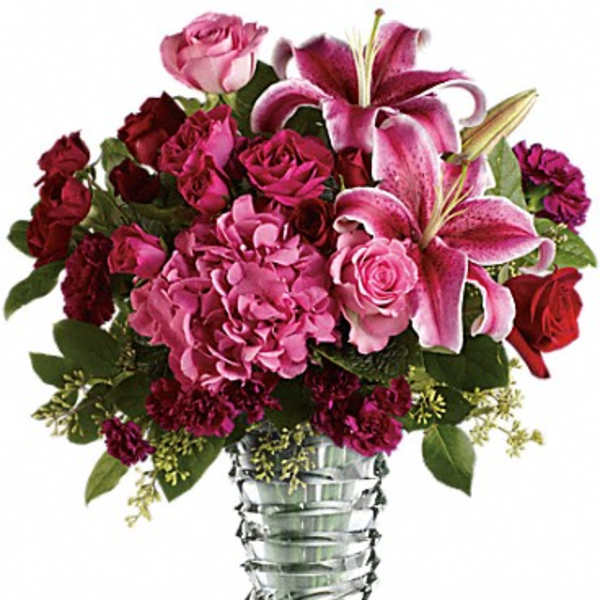 Pink and red floral arrangement in a clear glass vase