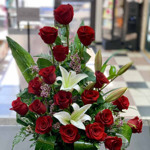 Red roses and white lilies in a compact bouquet