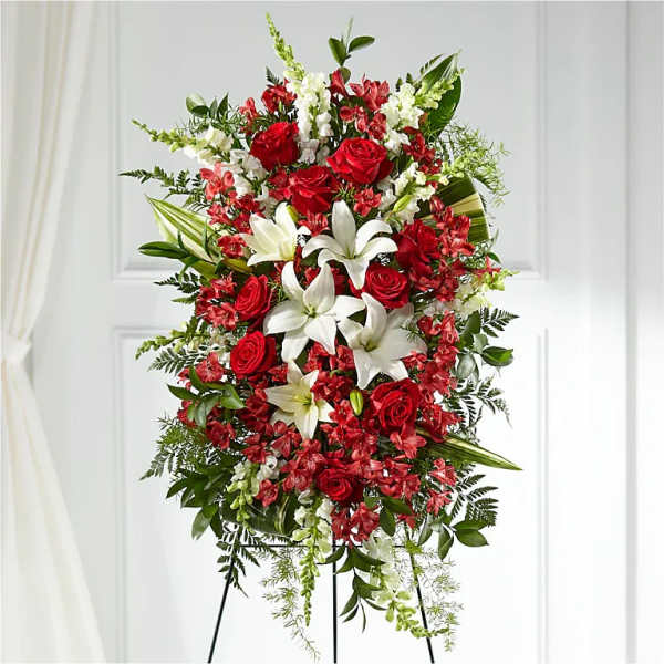 Standing spray of red roses and white lilies on an easel