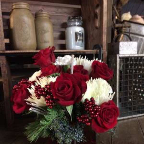 Red roses and white chrysanthemums in a dark vase