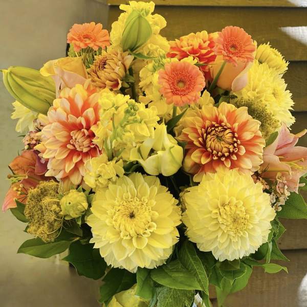 Yellow and orange mixed bouquet in a glass vase