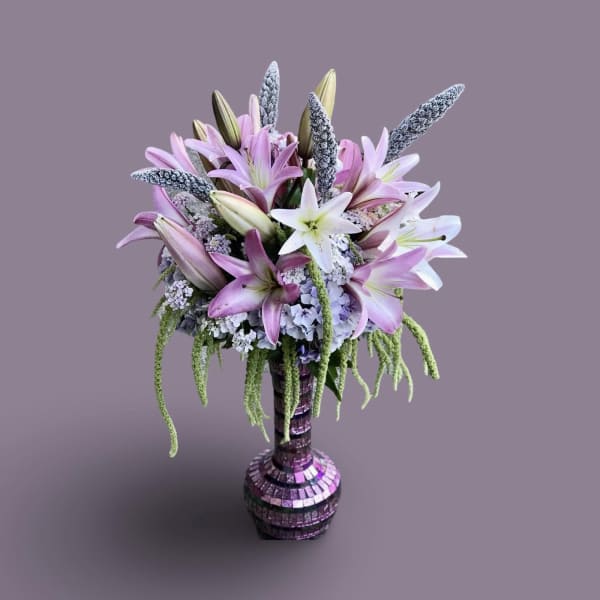 Bouquet of pink and white lilies in a mosaic vase