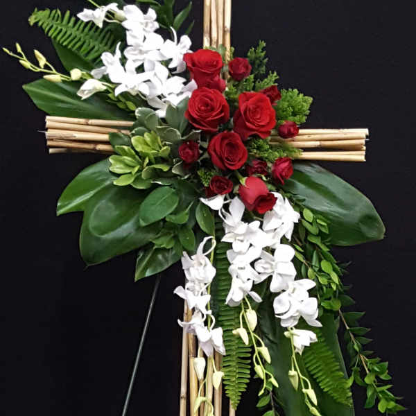 Floral cross with red roses and white orchids on a bamboo frame