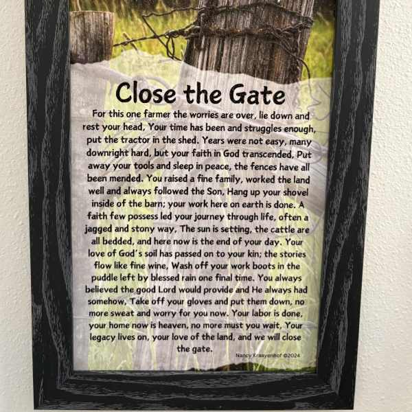 Framed memorial sign with a farm gate and poem text