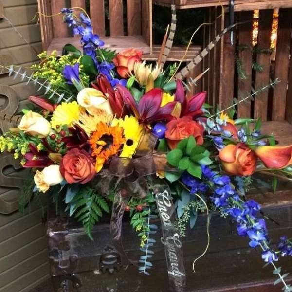 Colorful mixed flower arrangement with roses, lilies, and orchids