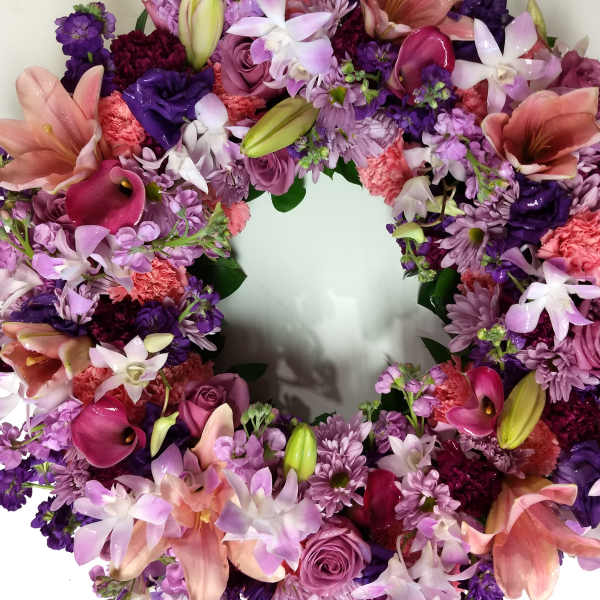 Heart-shaped floral wreath with pink, purple, and white blooms