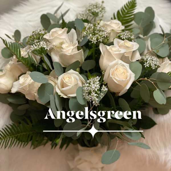 Cream roses arranged with eucalyptus and small white filler flowers