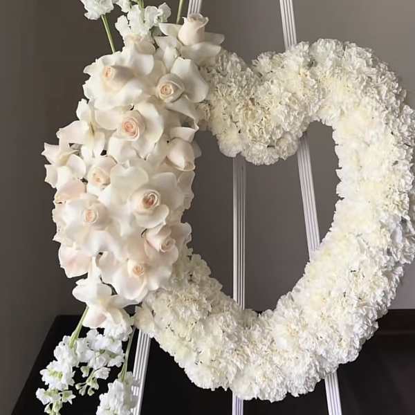 White floral wreath and cascading bouquet on a stand