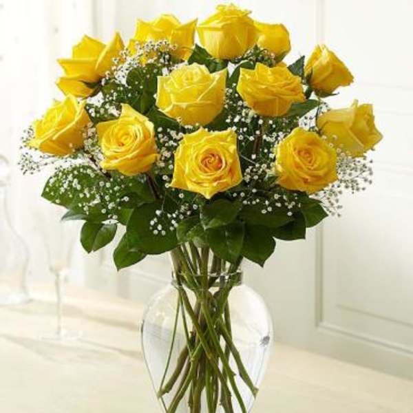 Yellow roses arranged in a clear glass vase