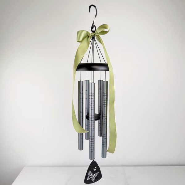 Hanging metal wind chime with a green ribbon and butterfly pendant