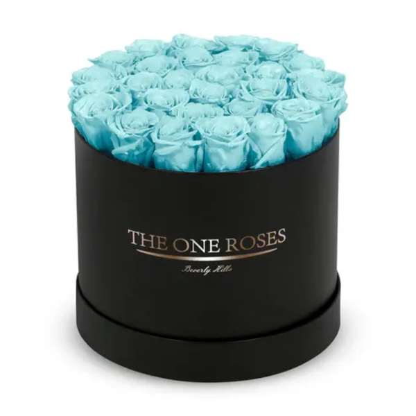 Round box of light blue roses on a black container