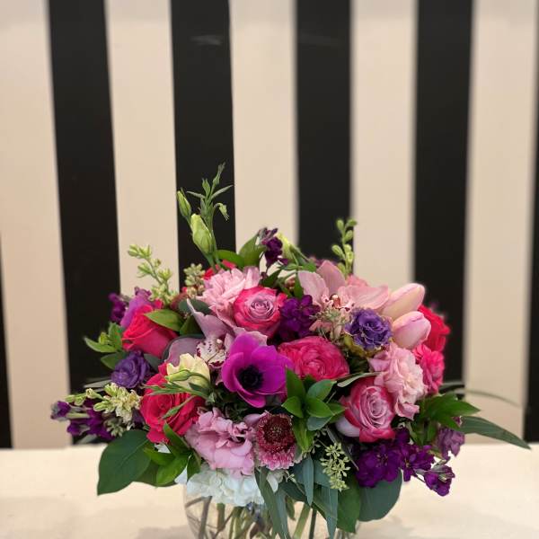 Pink and purple mixed bouquet in a clear glass vase