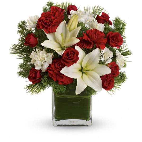 Red roses, white lilies, and carnations in a square glass vase