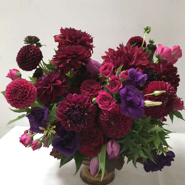 Bouquet of burgundy, pink, and purple flowers in a vase