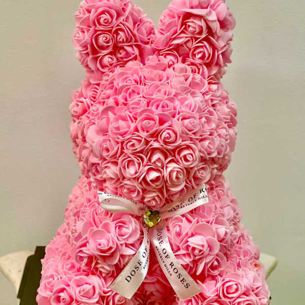Pink rose teddy bear with a ribbon bow