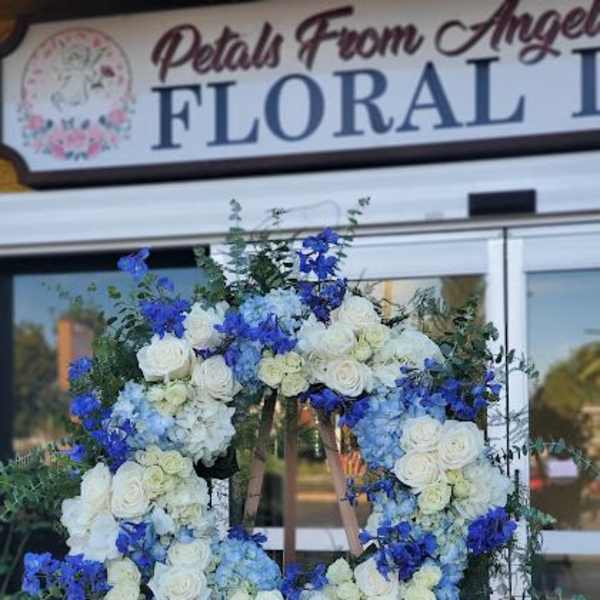 Large blue and white floral wreath on an easel