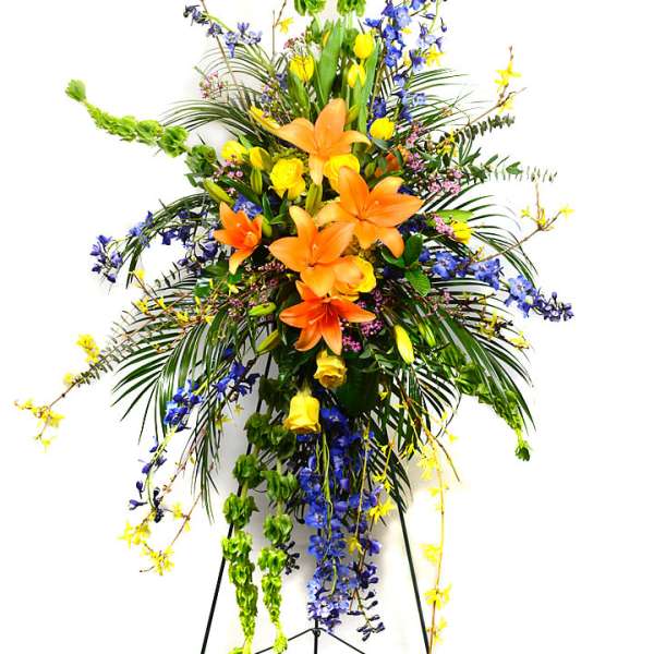 Tall floral spray with orange lilies and blue and yellow flowers