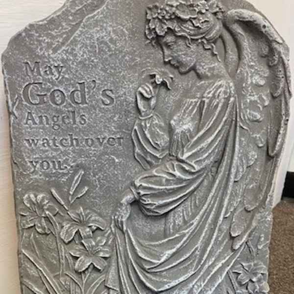 Gray stone plaque with an angel relief and engraved text