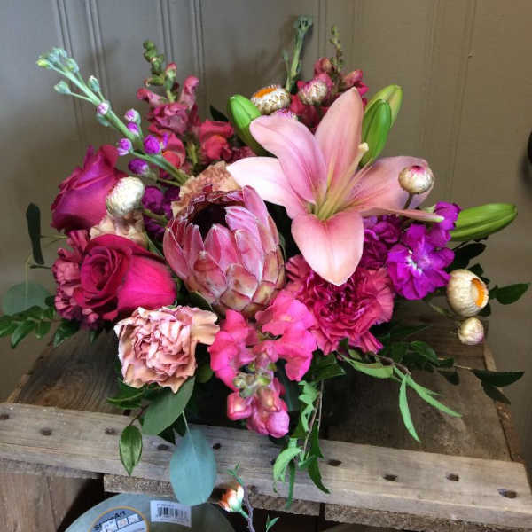 Pink lily and rose bouquet with protea and carnations