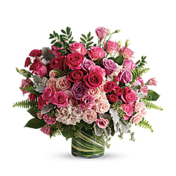 Pink and purple rose bouquet in a glass vase