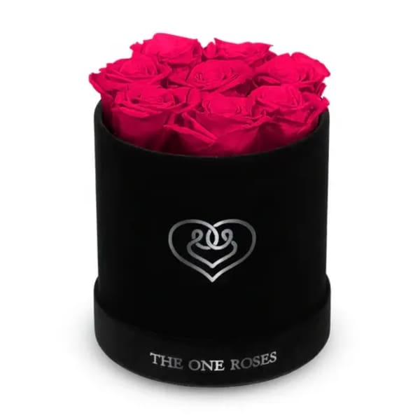 Hot pink roses arranged in a black round box
