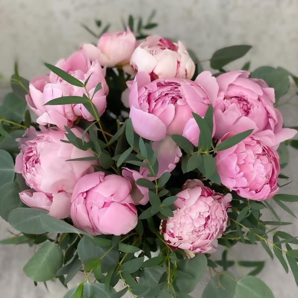 Bouquet of pink peonies with eucalyptus foliage