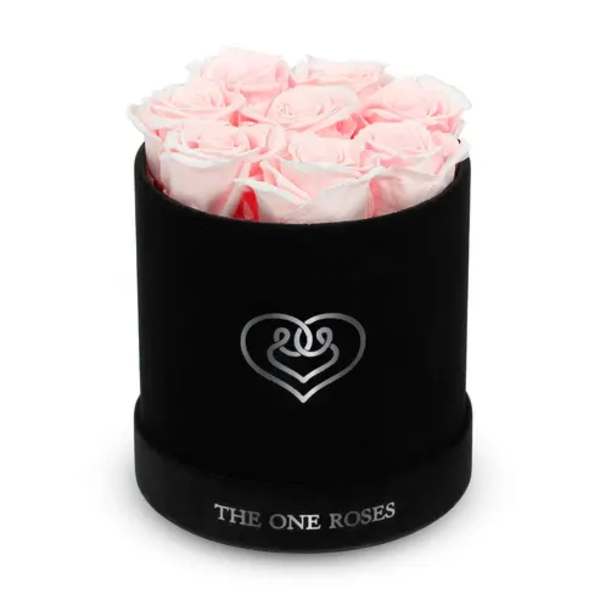Pink roses arranged in a black round box