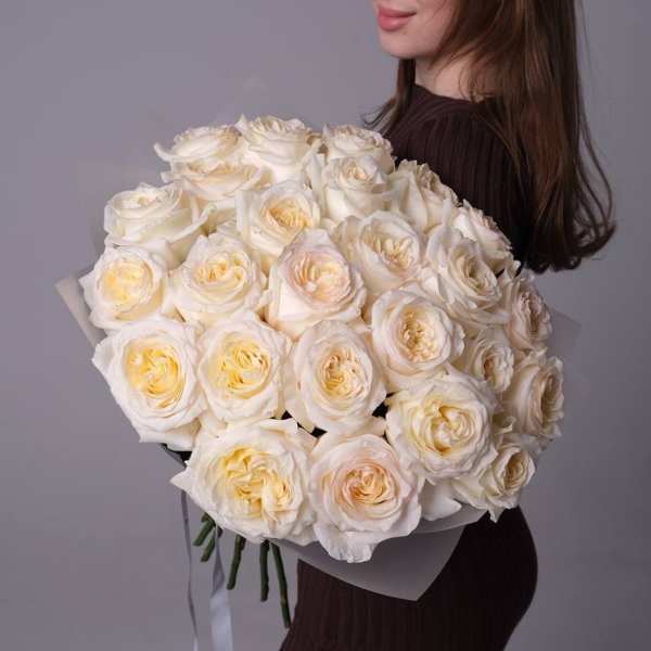 Woman holding a large bouquet of white roses
