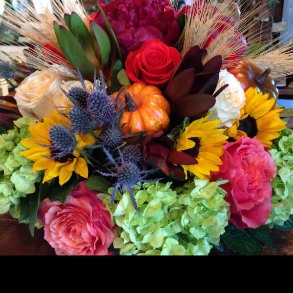 Mixed bouquet with sunflowers, roses, hydrangeas, and pumpkins