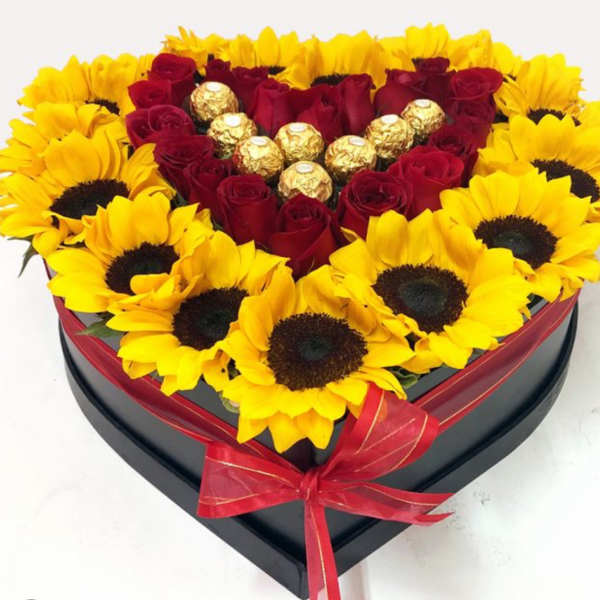 Heart-shaped box of red roses and sunflowers with gold chocolates