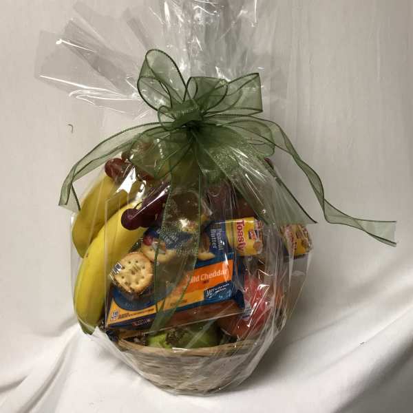 Gift basket with fruit and packaged snacks wrapped in clear cellophane