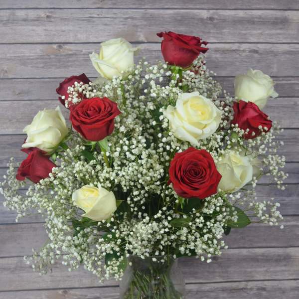 Bouquet of red and white roses in a clear glass vase