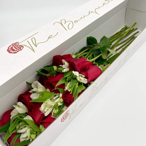 Long box of red roses and white flowers