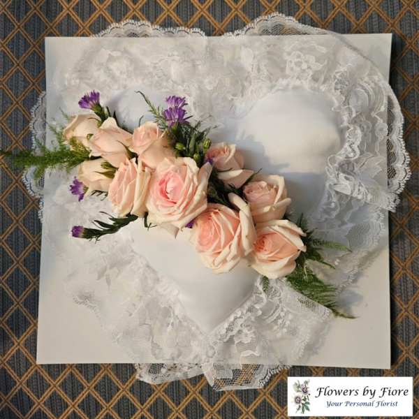 Lace heart-shaped pillow with a pale pink rose corsage
