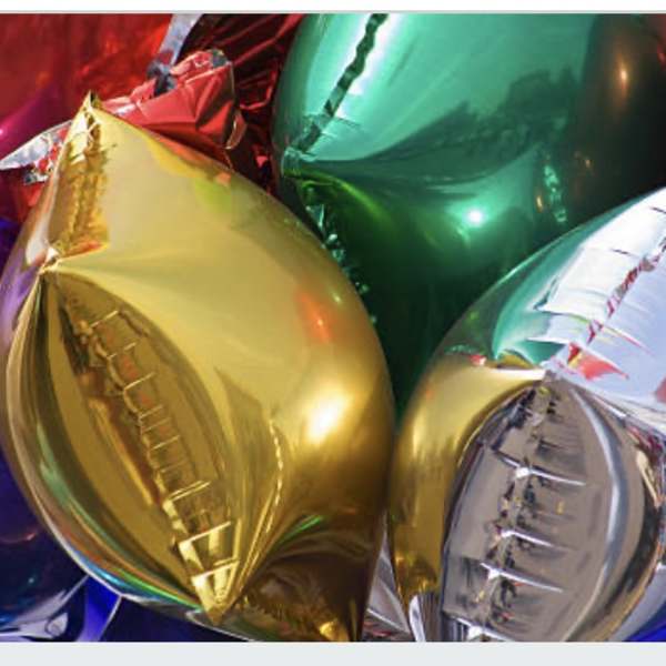 Cluster of shiny metallic balloons in red, gold, blue, green, and silver