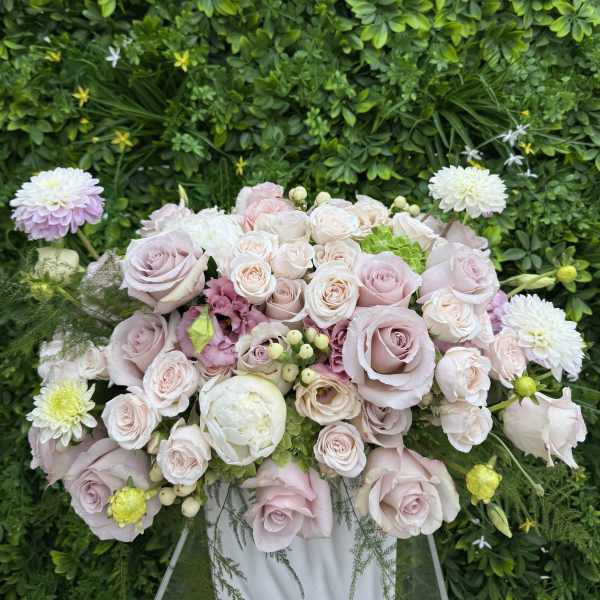 Pastel rose bouquet with white and pink blooms in a clear stand