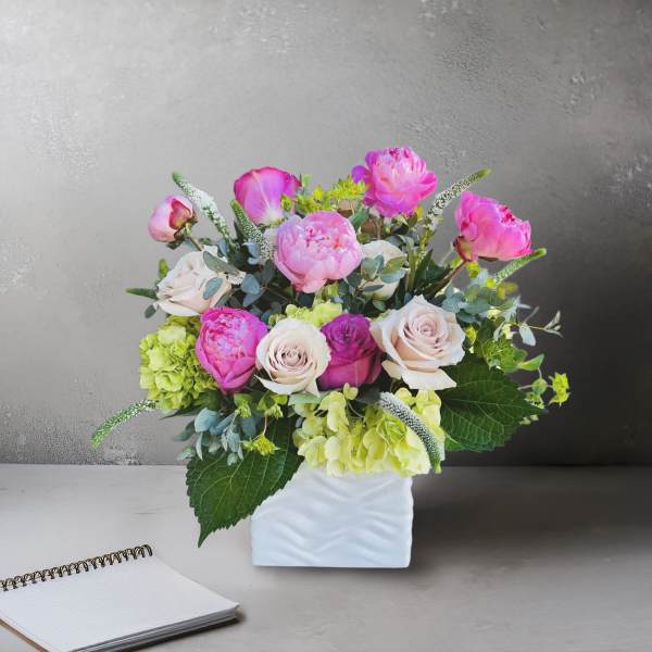 Pink and cream bouquet in a white vase