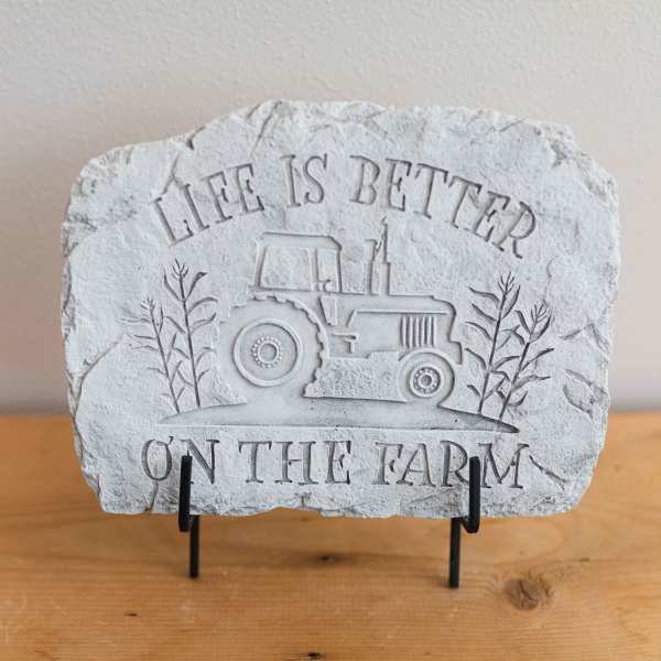 Stone plaque with a tractor and the words "Life is Better on the Farm"
