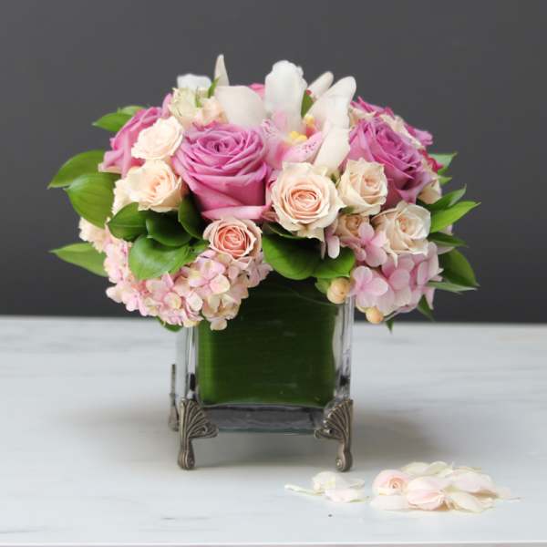 Pink and white rose bouquet in a glass vase