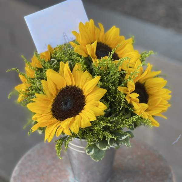 Sunflower bouquet in a metal bucket vase