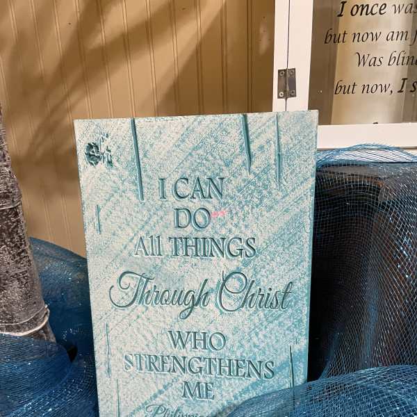 Decorative Christian sign with blue mesh ribbon and a small angel figure