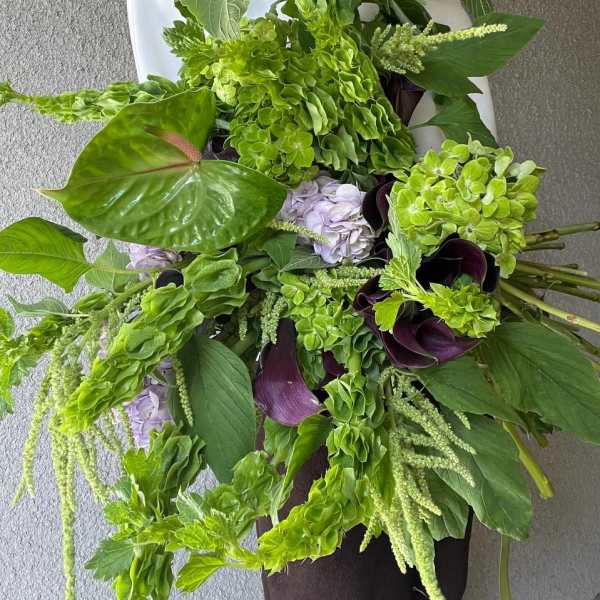 Large green bouquet with hydrangeas, calla lilies, and trailing blooms